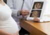 Pregnant woman consulting doctor about fetal growth scan ultrasound images.